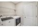 Convenient laundry room with washer, dryer, and shelving at 656 Argyll Dr, Spring Hill, FL 34609