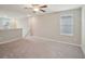 Bright and airy loft area with carpeted flooring and large windows at 656 Argyll Dr, Spring Hill, FL 34609