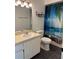 Bathroom with neutral countertops and a shower with a tropical-themed curtain at 7806 Amberlea Ct, Temple Terrace, FL 33637