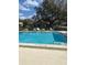 Community pool with lounge chairs and clear blue water for residents to enjoy at 7806 Amberlea Ct, Temple Terrace, FL 33637