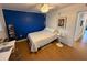 Bright bedroom with wood floors and a blue accent wall at 8101 113Th Street St # 107, Seminole, FL 33772