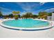 Community pool with surrounding lounge chairs at 8101 113Th Street St # 107, Seminole, FL 33772