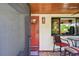 Charming front porch with red door and seating area at 830 23Rd N Ave, St Petersburg, FL 33704