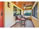 Screened porch with ceiling fan and bistro set at 830 23Rd N Ave, St Petersburg, FL 33704