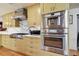 Modern kitchen with stainless steel appliances and yellow cabinets at 830 23Rd N Ave, St Petersburg, FL 33704