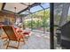 Relaxing screened patio with seating and a view of the backyard at 830 23Rd N Ave, St Petersburg, FL 33704