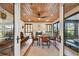 Sunroom with wood ceiling, fireplace, and comfortable seating at 830 23Rd N Ave, St Petersburg, FL 33704