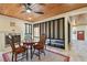 Sunroom with fireplace, wood ceiling and a round wooden table with chairs at 830 23Rd N Ave, St Petersburg, FL 33704