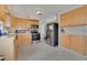 Galley-style kitchen with light wood cabinets and stainless steel appliances at 960 43Rd Ne Ave, St Petersburg, FL 33703