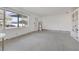 Living room with terrazzo floors, large window, and built-in shelving at 960 43Rd Ne Ave, St Petersburg, FL 33703