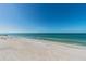 Expansive beach view with clear water and pier at 108 13Th Ave, Indian Rocks Beach, FL 33785