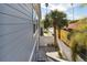 Landscaped side yard with a gated entrance and stairs at 108 13Th Ave, Indian Rocks Beach, FL 33785