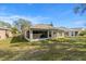 Spacious backyard with grassy lawn and screened patio at 10833 Collar Dr, San Antonio, FL 33576