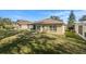 Large backyard featuring a screened patio and grassy area at 10833 Collar Dr, San Antonio, FL 33576