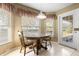 Charming breakfast nook with wood table and chairs, overlooking the backyard at 10833 Collar Dr, San Antonio, FL 33576