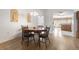 Bright dining room featuring wood flooring and a view into the kitchen at 10833 Collar Dr, San Antonio, FL 33576
