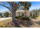 House exterior showcasing a two-car garage and lush landscaping at 10833 Collar Dr, San Antonio, FL 33576