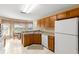 Kitchen with wood cabinets, white appliances, and a breakfast nook at 10833 Collar Dr, San Antonio, FL 33576