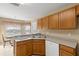Kitchen boasts oak cabinets, white appliances, and a breakfast bar at 10833 Collar Dr, San Antonio, FL 33576