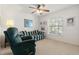 Relaxing living room with a comfy recliner and striped couch at 10833 Collar Dr, San Antonio, FL 33576