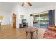 Living room with wood floors, comfy furniture, and access to a screened patio at 10833 Collar Dr, San Antonio, FL 33576