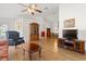 Living room with hardwood floors, comfy seating and a view into dining area at 10833 Collar Dr, San Antonio, FL 33576