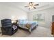 Main bedroom with carpeted floors and a comfortable bed at 10833 Collar Dr, San Antonio, FL 33576