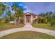 Two-story house with circular driveway and landscaping at 1103 Wild Citrus Ln, Sarasota, FL 34240