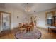 Dining room with hardwood floors, round table, and access to kitchen at 1211 E Clifton St, Tampa, FL 33604