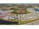 Aerial view of houses and a lake in a new community at 12143 Kingsley Trl, Parrish, FL 34219