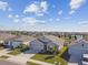 One-story house with gray roof, three-car garage, and landscaped yard at 12143 Kingsley Trl, Parrish, FL 34219