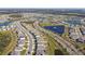 Aerial view of a community with lakes, houses, and landscaping at 12143 Kingsley Trl, Parrish, FL 34219