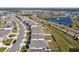 Aerial view of a neighborhood with houses, roads, and a pond at 12143 Kingsley Trl, Parrish, FL 34219
