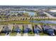 Aerial view of a neighborhood with houses, roads, and a pond at 12143 Kingsley Trl, Parrish, FL 34219