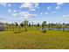 Backyard with grassy lawn and pond view at 12143 Kingsley Trl, Parrish, FL 34219