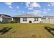 House backyard with grassy lawn at 12143 Kingsley Trl, Parrish, FL 34219