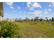 Spacious backyard with grassy lawn and pond view at 12143 Kingsley Trl, Parrish, FL 34219