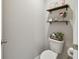 Small toilet and sink bathroom with floating shelves at 12143 Kingsley Trl, Parrish, FL 34219