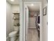 Small toilet and sink bathroom with floating shelves at 12143 Kingsley Trl, Parrish, FL 34219