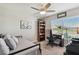 Versatile bedroom with a daybed, workspace, and ceiling fan at 12143 Kingsley Trl, Parrish, FL 34219