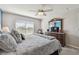 Spacious bedroom with a large bed, dresser, and window with blinds at 12143 Kingsley Trl, Parrish, FL 34219