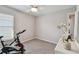 Bedroom with a window, exercise bike and dresser at 12143 Kingsley Trl, Parrish, FL 34219