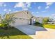 Two-story house with a two-car garage and a neatly landscaped lawn at 12143 Kingsley Trl, Parrish, FL 34219