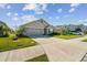 Two-story house with a two-car garage and a neatly landscaped lawn at 12143 Kingsley Trl, Parrish, FL 34219