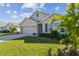 Two-story house with a two-car garage and a neatly landscaped lawn at 12143 Kingsley Trl, Parrish, FL 34219