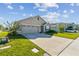 Two-story house with a two-car garage and a neatly landscaped lawn at 12143 Kingsley Trl, Parrish, FL 34219