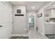 Clean hallway with tile floors and laundry access at 12143 Kingsley Trl, Parrish, FL 34219