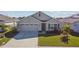 Tan house with two car garage and palm trees at 12143 Kingsley Trl, Parrish, FL 34219