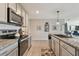 Modern kitchen with granite counters and stainless steel appliances at 12143 Kingsley Trl, Parrish, FL 34219
