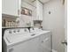 Laundry room with washer, dryer, and storage shelves at 12143 Kingsley Trl, Parrish, FL 34219